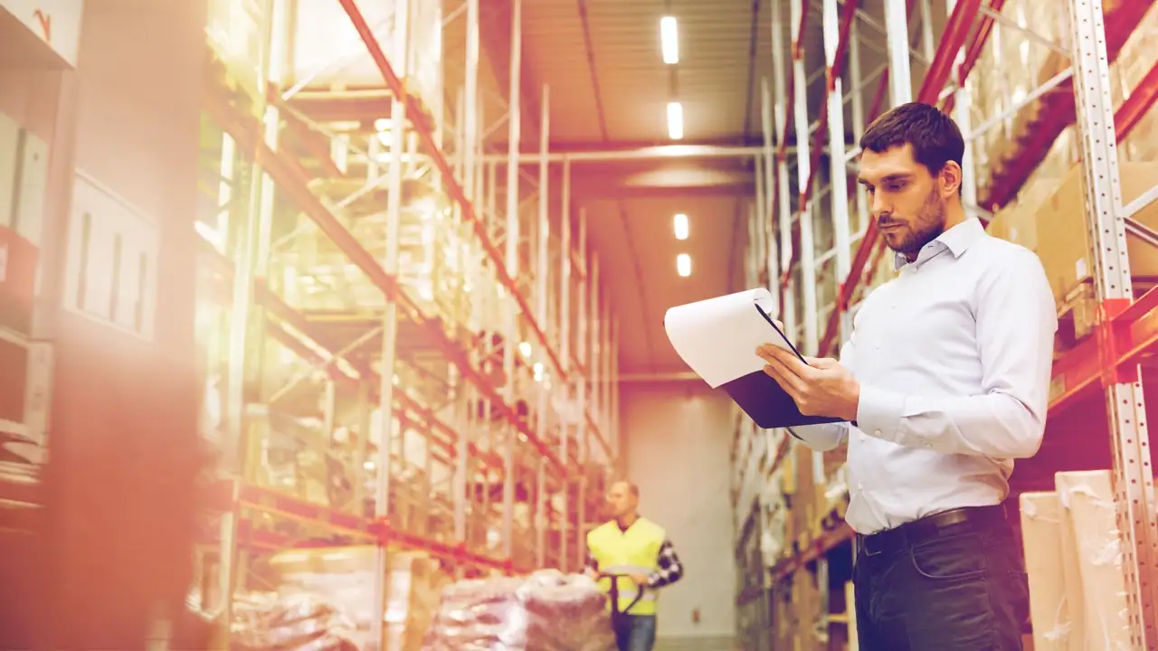 Profesional de la carrera en diseño industrial revisando documentos en su área de trabajo.